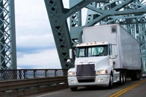 White semi-truck crossing bridge